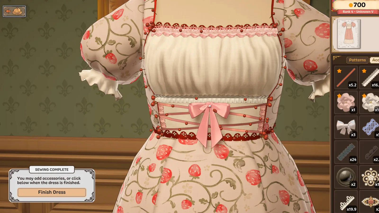 Lace trim and bow pinned along the strawberry print dress on the mannequin